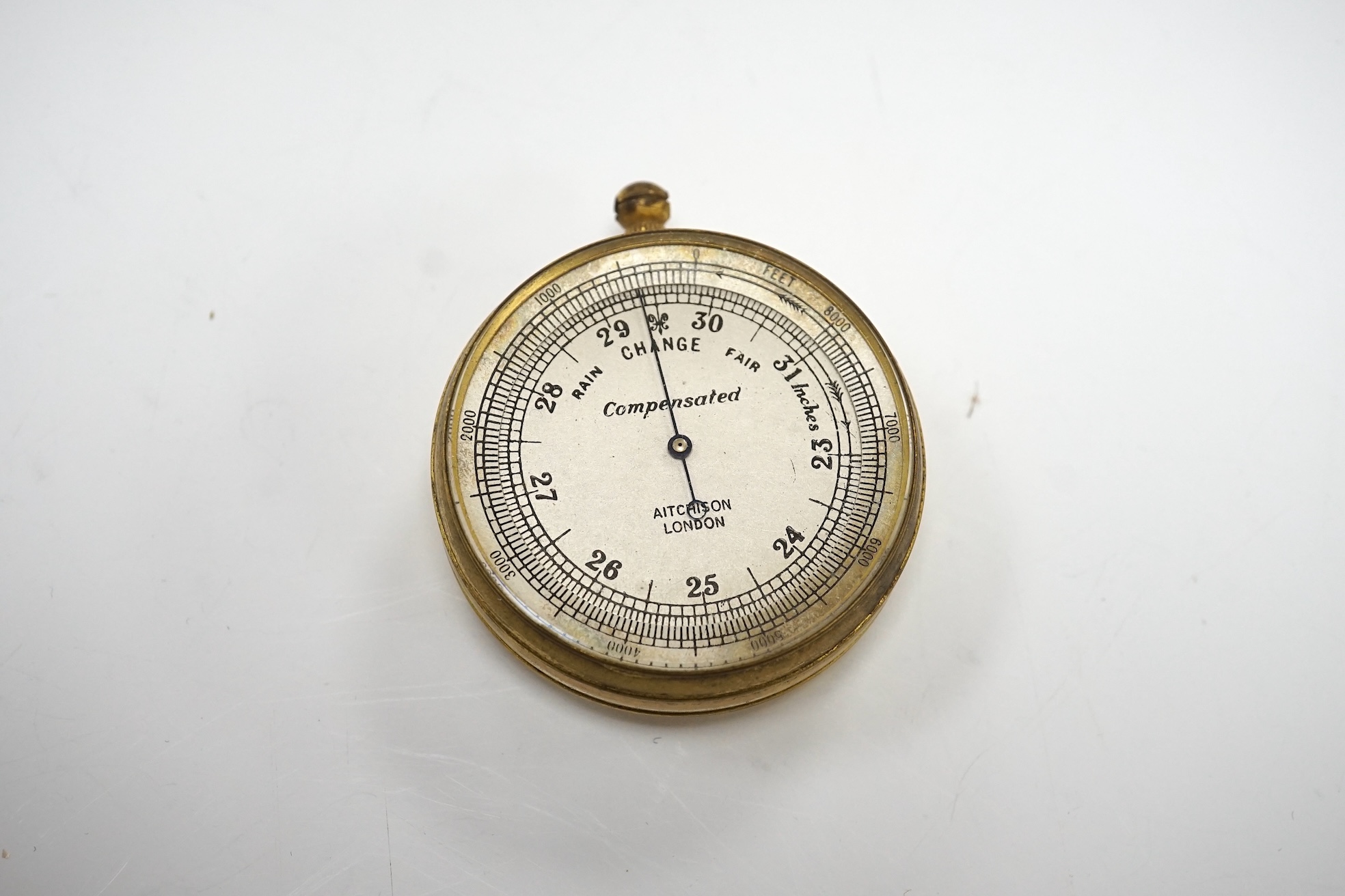 An Aitchison pocket barometer housed in original leather case, overall 6cm in diameter. Condition - fair